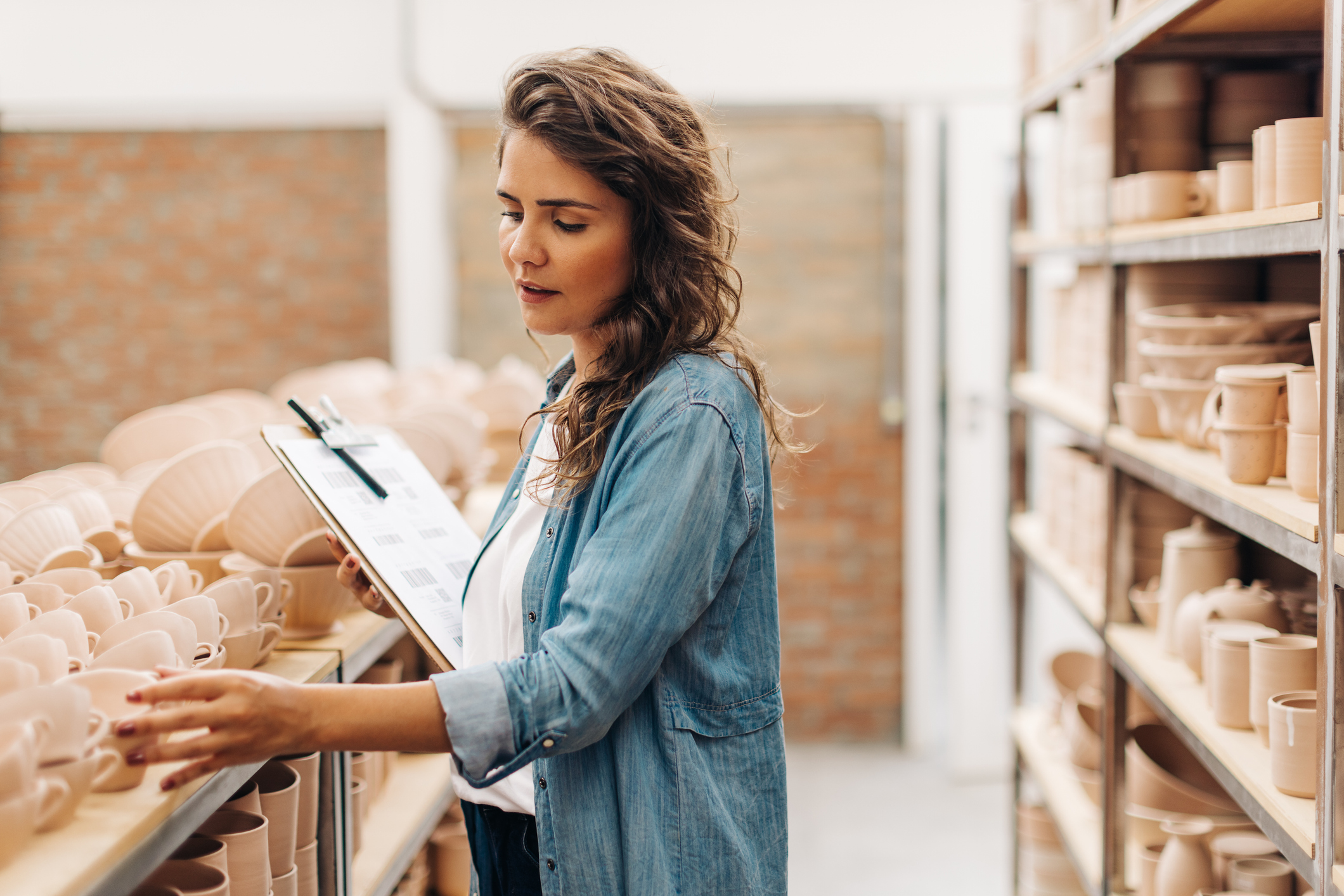 Woman with clipboard doing inventory stock count