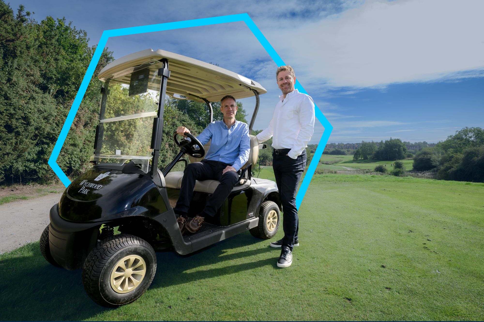 Two people are sitting the golf car.