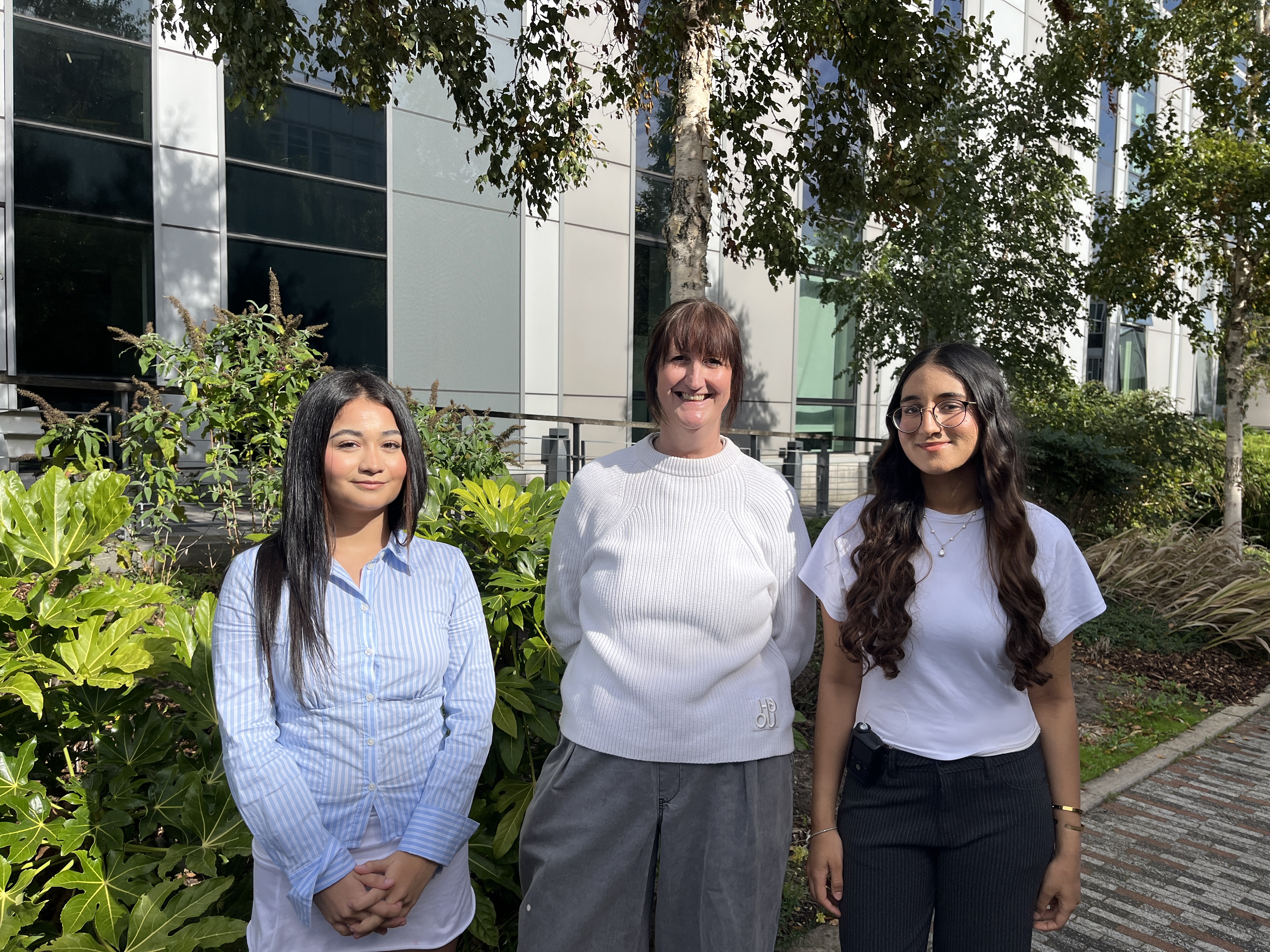Three professionals outside an office building. Jeannie Paschalis, GM Business Growth Hub Organisational Development Specialist: Green Sector and Skills Pathways (middle) with T Level students 